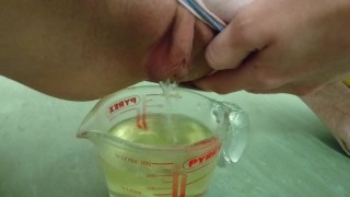 pee in measuring cup | close up