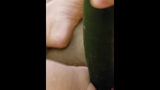 Busty woman plays with cucumber