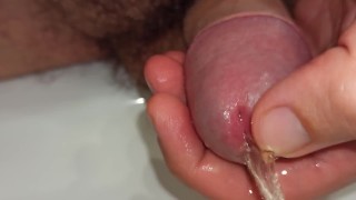 close up pissing and playing with peehole