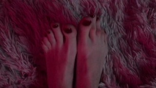 pretty long feet with red painted toenails