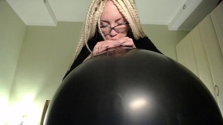 Blow big black balloon & pop with nails