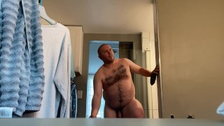Fat guy getting ready for shower