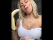Preview 5 of Sexy blonde with huge breasts seduced and eats a banana