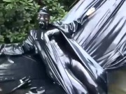 Preview 1 of Latex girl full in black rubber and Gasmask chill outs outdoor in garden in a heavy rubber hammock