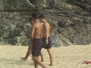 Preview 3 of Sensual Tanned Dark Haired Hunk Takes Two Dicks On The Sand!