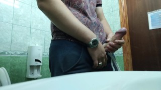 Russian young guy jerks off at work in the toilet