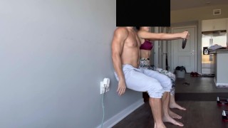 Fit couple doing wall squats to failure