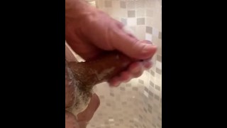 Hot guy covers body with soap in shower