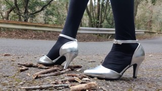 Outdoor LeatherWomen's high heels crush and crush tree branches with a crash fetish.