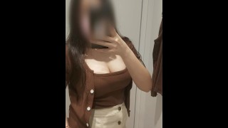 Asian girl trying clothes in fitting room