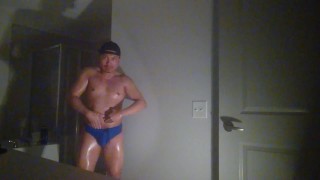 Oiled up and posing while wearing Speedos!