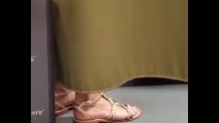 Sexy feet of a French girl in the fitting room of a sports store