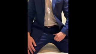 Mr. Lovegrooves takes his suit off and strokes until he cums