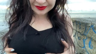 Hot Mistress Lara is touching her big tits and masturbates at public beach