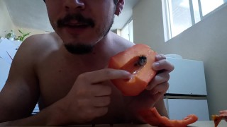 Handsome guy fucks a papaya, cums inside and eats it