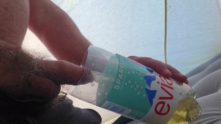 Pissing in a bottle in a tent while camping