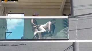 Neighbor films couple having sex on the balcony of the building she moans a lot