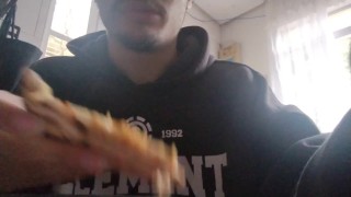 Boy eats a pizza for lunch