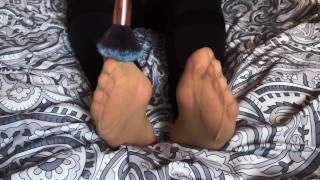 Feet tickling in nylon
