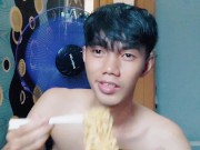 Preview 1 of Handsome young man is eating noodles without using t shirt
