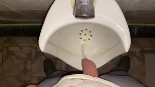 Hands-free pissing in a public toilet from an uncut dick