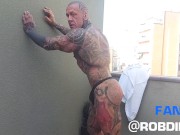Preview 4 of The legend of muscles and ink: Tattooed giant Rob Diesel, shows his power on the balcony
