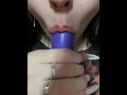 Preview 4 of A cute girl sucks on a purple toy.