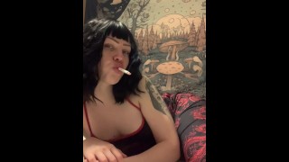 sexy woman smokes at the window