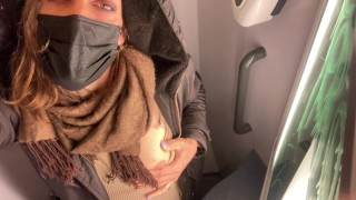 She touches her little tits on the train