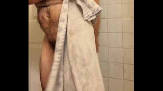Hairy muscle bear flexing in hot shower